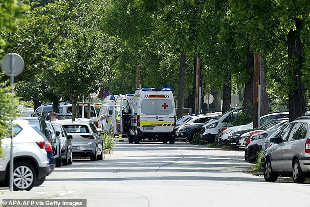 Ambulance cars are seen in a street close to a school where, according to reports, several people died in a shooting, on June 10, 2025 in Graz, southeastern Austria