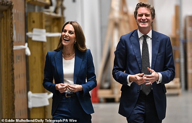 Kate shares a laugh with the director of the V&A storehouse during her visit on Tuesday morning