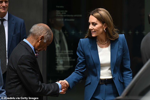 Princess Kate of Wales speaks to officials as she leaves the V&A East Storehouse