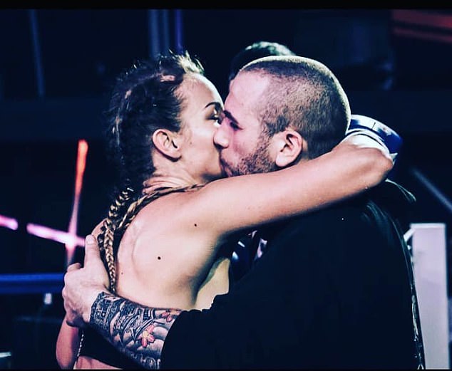 Mr Zetolofsky is pictured embracing his wife Katie after a boxing bout she was competing in