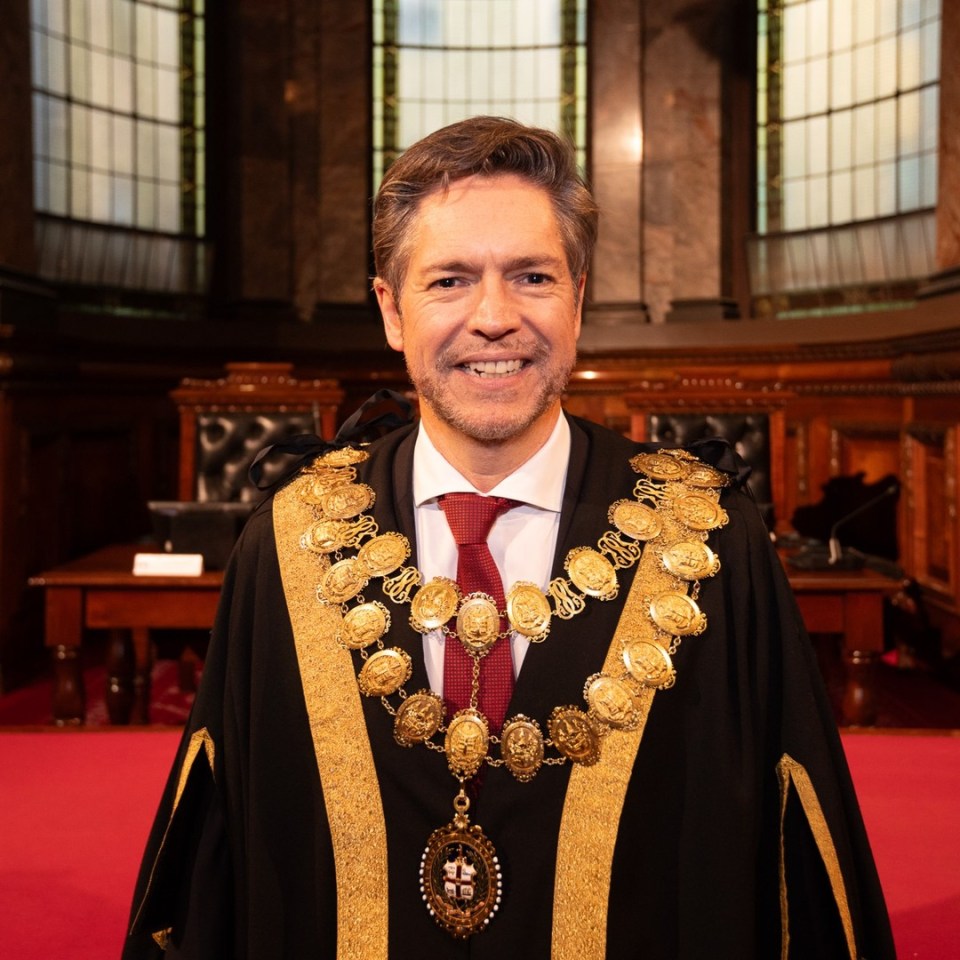 Portrait of a man wearing a mayoral chain of office.