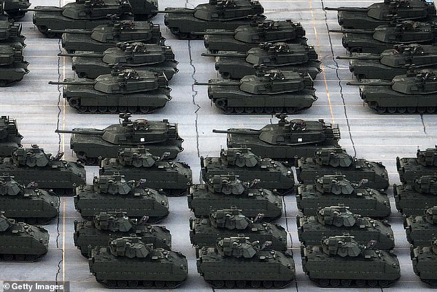 U.S. Army vehicles, including M1 Abrams tanks and Bradley FIghting Vehicles, are are loaded onto tractor trailer trucks in the CSX rail yard in Jessup, Maryland on Monday ahead of Saturday's Army parade
