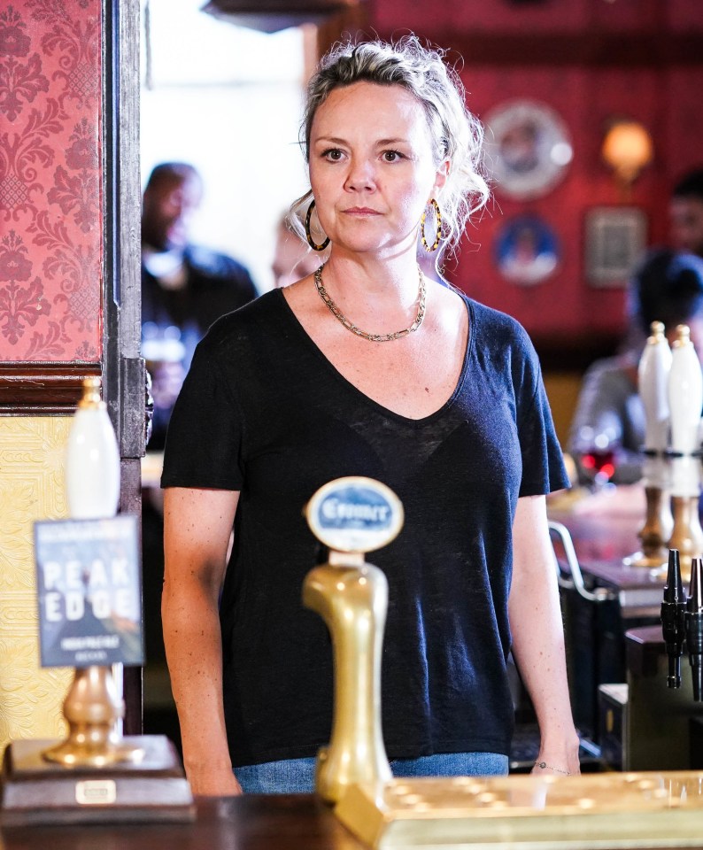 Janine Butcher behind a pub bar.