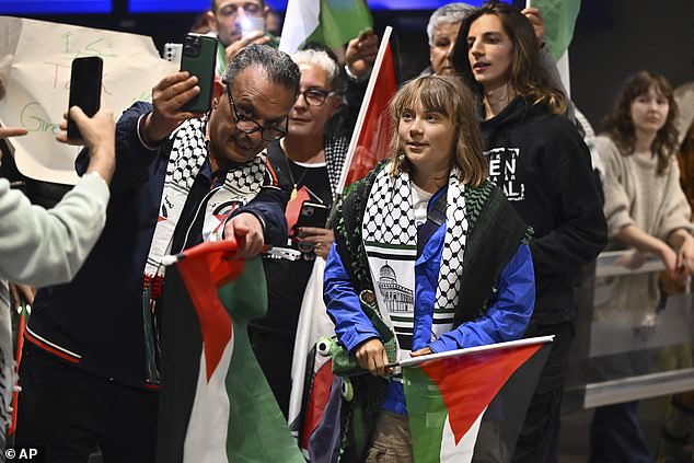 Of the 12 people on board the sailing boat Madleen, two French nationals agreed to be deported on June 10, while four others declined pending a court decision. Pictured: Thunberg was greeted by around 30 cheering supporters waving Palestinian flags amid a large media presence at the airport