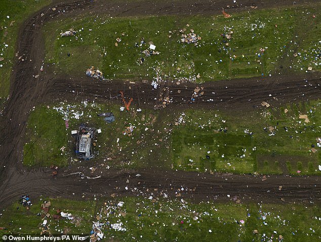 A van that caught fire is surrounded by rubbish in a field on Monday after the Appleby Horse Fair