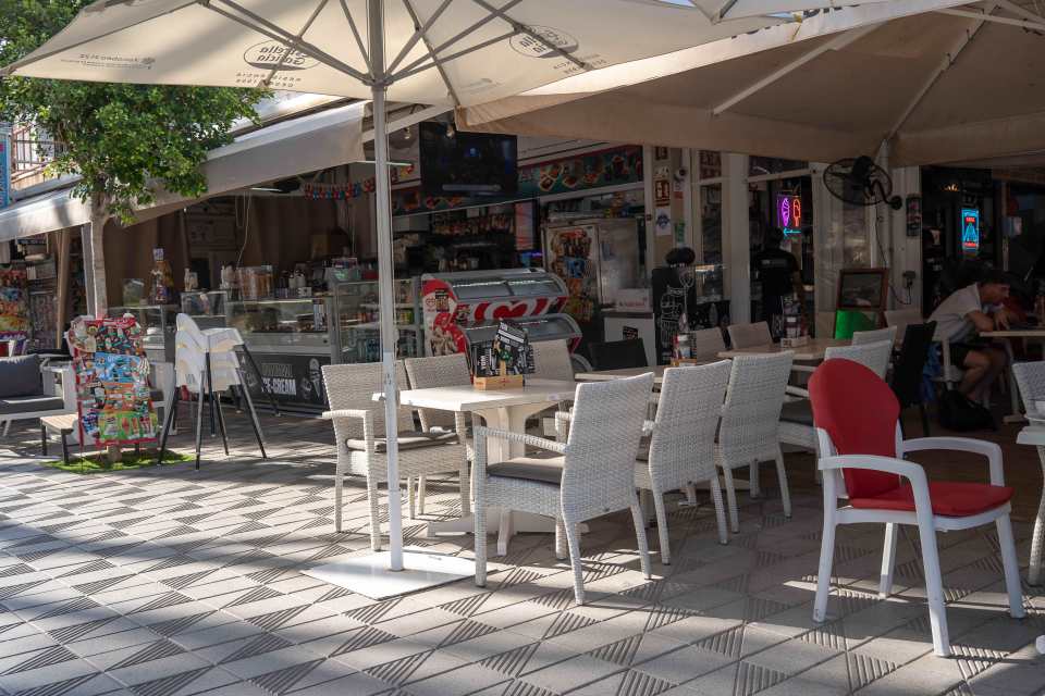 Empty tables and chairs at an outdoor cafe in Magaluf.
