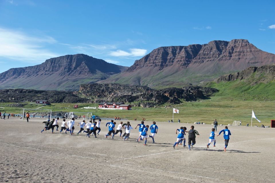 Greenlandic boys playing soccer near Qeqertarsuaq.
