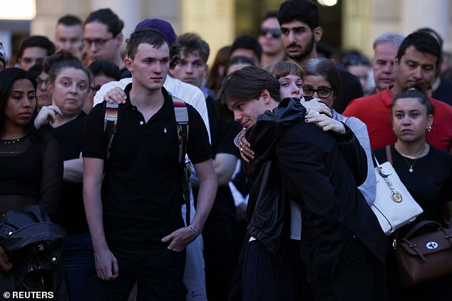 People embrace as they gather on the main square following a deadly school shooting in Graz, Austria, June 10, 2025