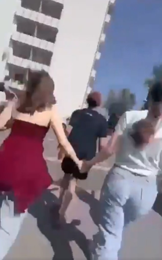 Footage shows terror-stricken pupils run down a corridor and a flight of stairs as they are escorted out of the building by heavily armed police