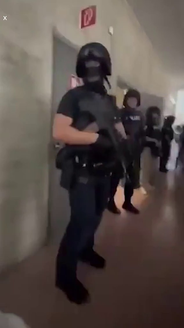 Ten people were killed and more than a dozen others were wounded as shots and screams rang out when a shooter stormed into his old classroom and gunned down students and teachers. Pictured: Special forces officer evacuates the school following the deadly shooting in Graz