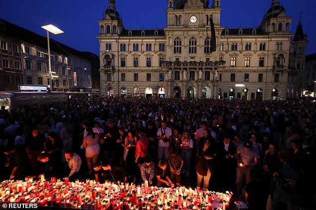 Today, a nationwide minute's silence will be held at 10am local time. Flags on the Hofburg Palace in Vienna, where the president has his office, will fly at half mast. Pictured: People light candles in the main square