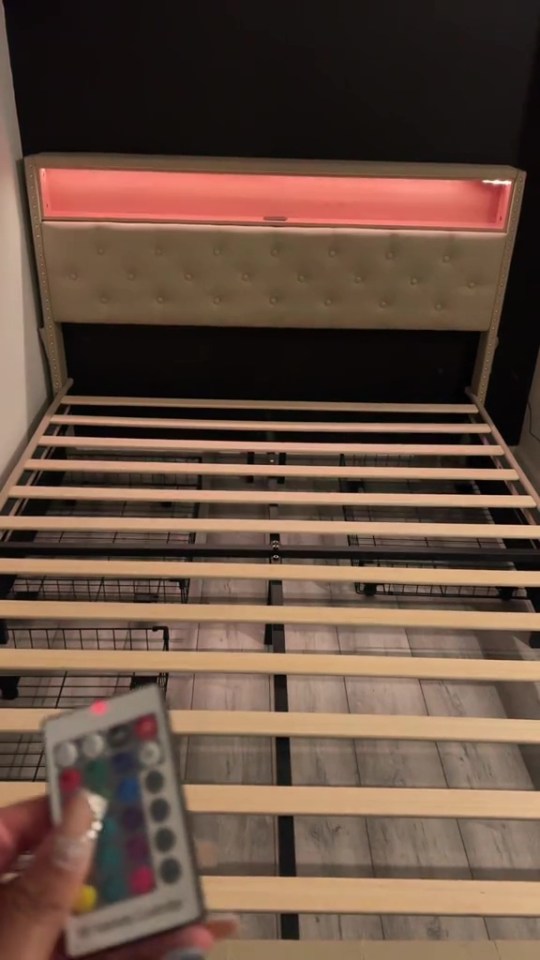 Bed frame with LED headboard and remote control.