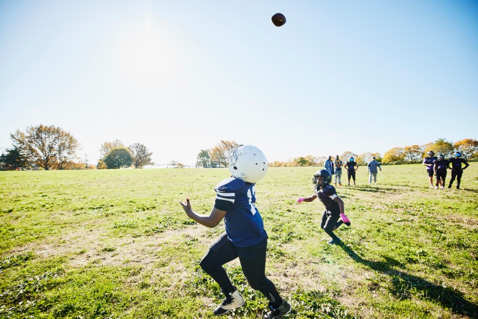 Young football players practicing on a field.