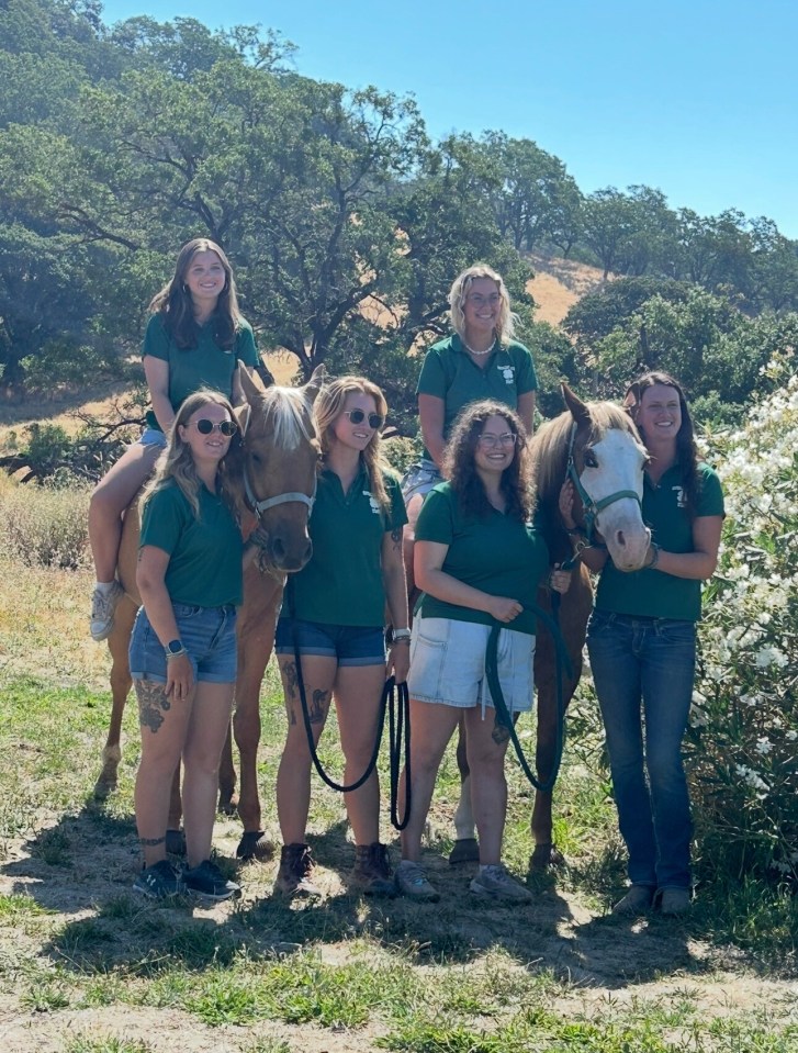 Group of women with horses at Camp America.