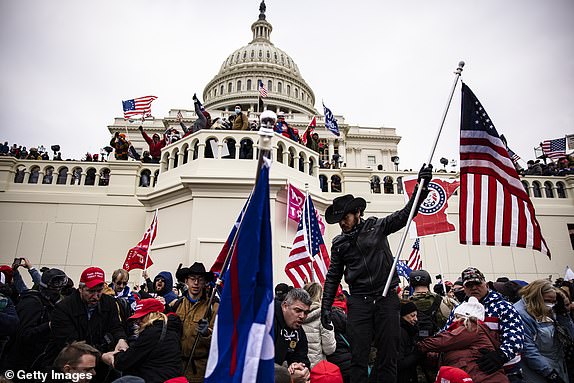 WASHINGTON, DC - JANUARY 06: Pro-Trump supporters storm the U.S. Capitol following a rally with President Donald Trump on January 6, 2021 in Washington, DC. Trump supporters gathered in the nation's capital today to protest the ratification of President-elect Joe Biden's Electoral College victory over President Trump in the 2020 election. (Photo by Samuel Corum/Getty Images)