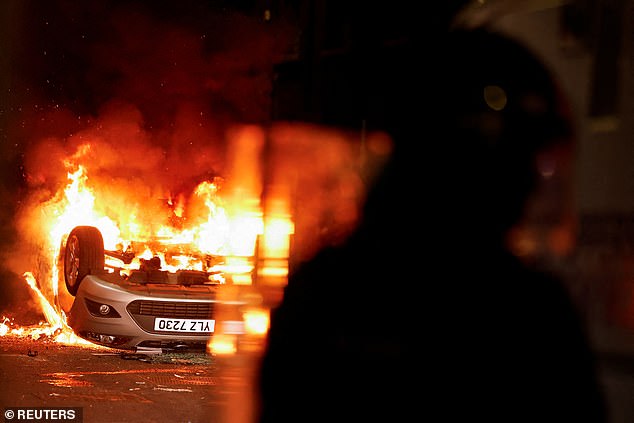 A vehicle burns during a second night of riots in Ballymena