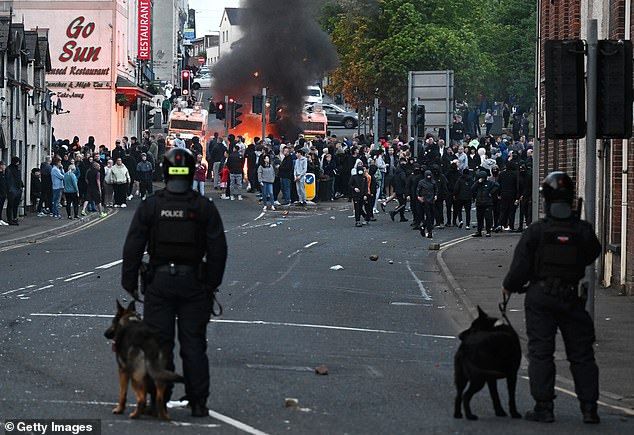 Police dogs attend the scene to assist officers and attempt to control the chaos