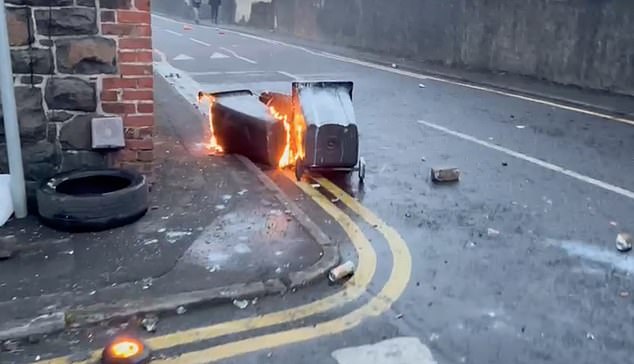 Wheelie bins are set on fire during the riot in Ballymena on Tuesday which spiralled out of control