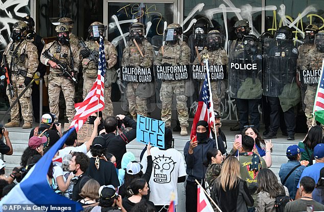 California National Guard and US Customs and Border Protection watch demonstrators gather in front the Federal Building