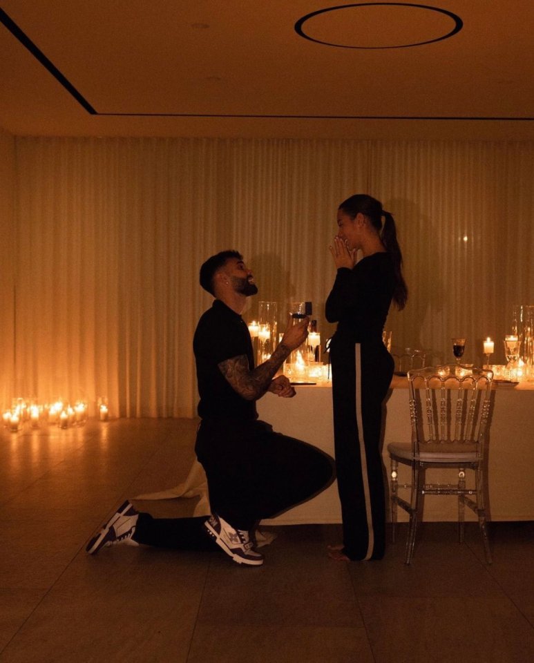 Man proposing to woman by candlelight.