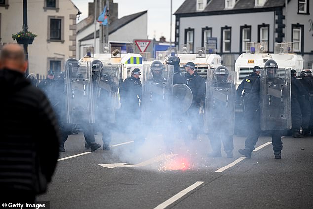 PSNI riot squad officers form a blockade on Harryville bridge in Ballymena tonight to stop potential rioters from accessing the Clonavon terrace area