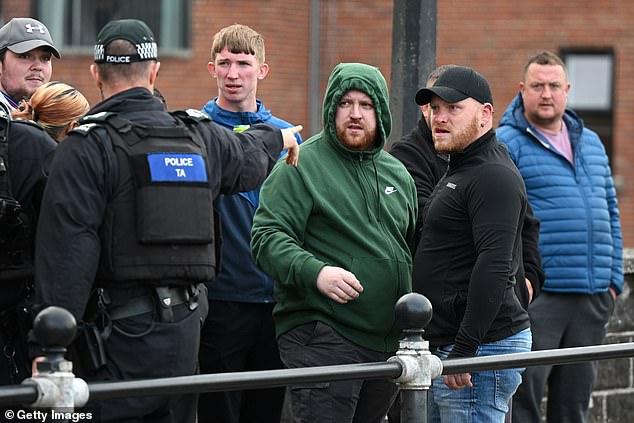 Police clash with residents during a third evening of unrest in Ballymena, Northern Ireland