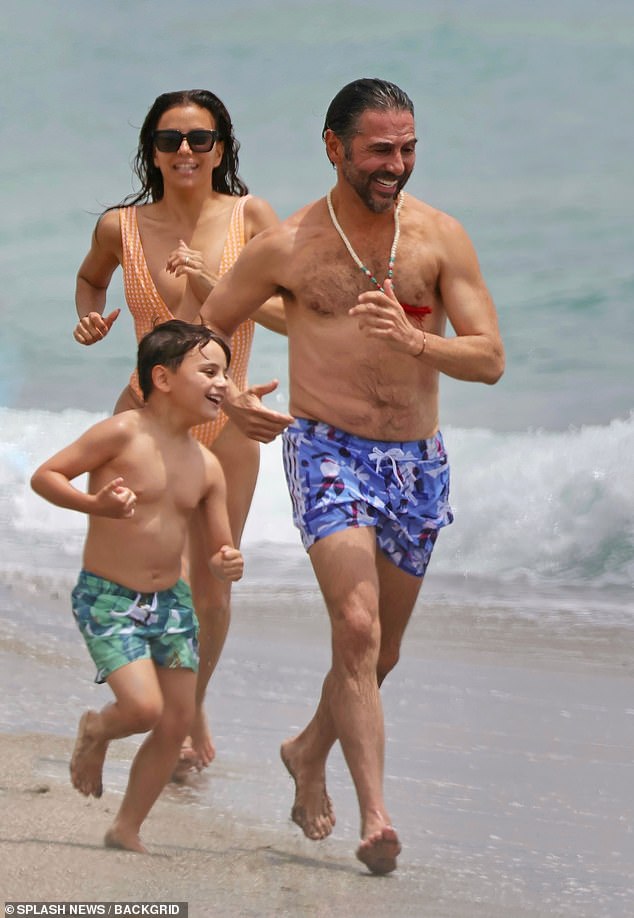 The trio jogged barefoot down the shore