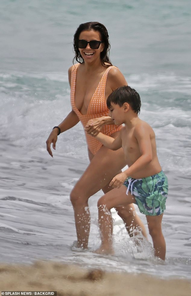 Eva grinned as she walked towards the shore with her son