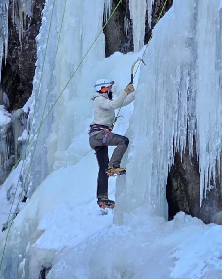 Woman ice climbing.
