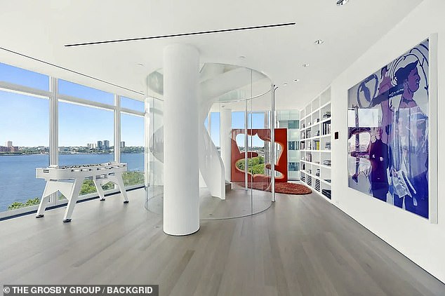 The three floors are connected via a spiral staircase and the luxe abode also boasts seven bathrooms
