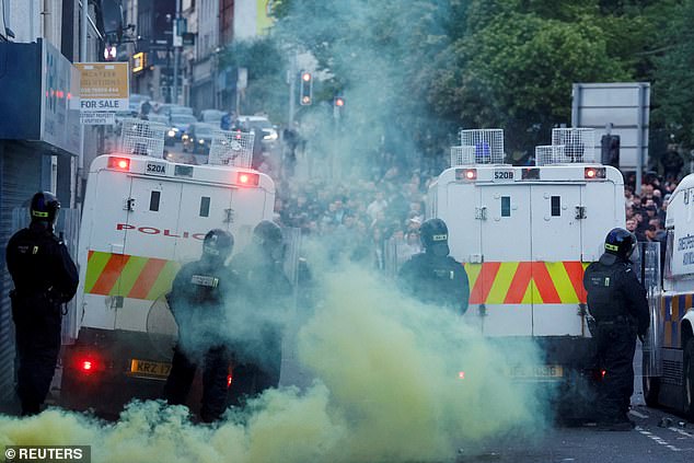 PSNI riot squad officers form a blockade on Harryville bridge in Ballymena to stop potential rioters from accessing the Clonavon terrace area