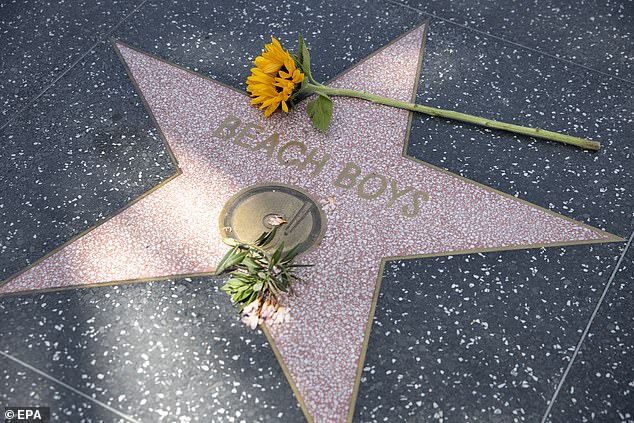 Flowers lie on the Beach Boys' Hollywood Walk of Fame star in Los Angeles, California, USA, 11 June 2025