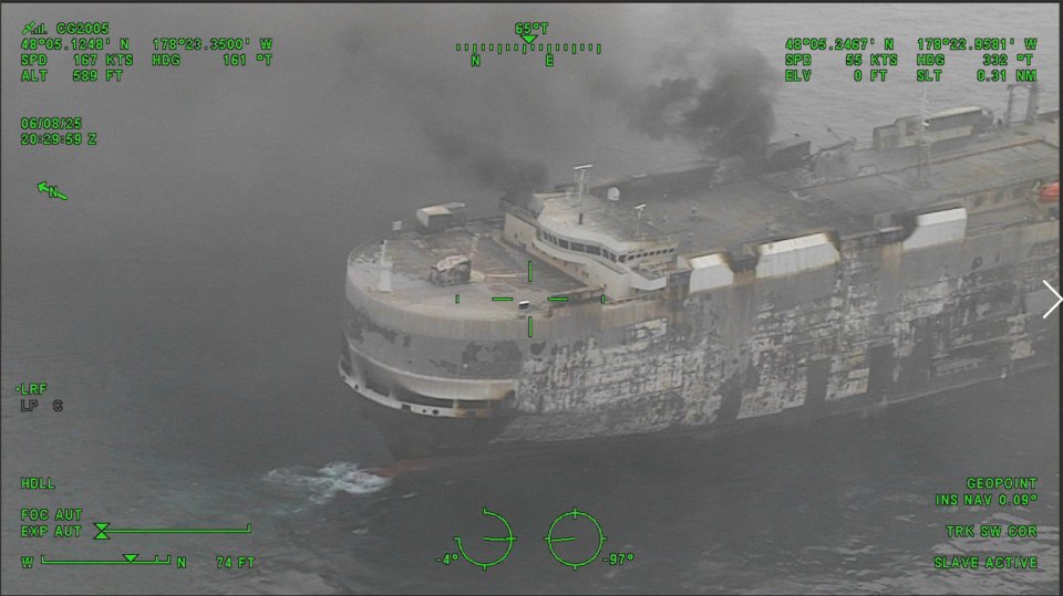 Aerial view of a damaged vessel drifting at sea.