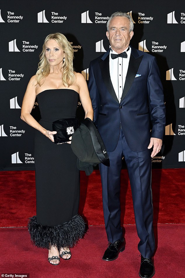 Actress Cheryl Hines (left) and Health and Human Services Secretary Robert F. Kennedy Jr. (right) walk the red carpet at the opening night of Les Miserables at the Kennedy Center