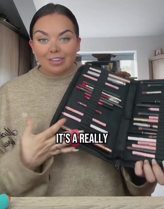 Woman holding a case filled with lip liners.