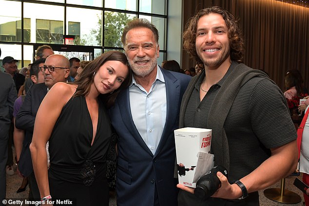 Arnold appeared to also be close with his son Joseph's girlfriend, the Dutch model Mel, as she was seen resting her head on his shoulder inside the theater