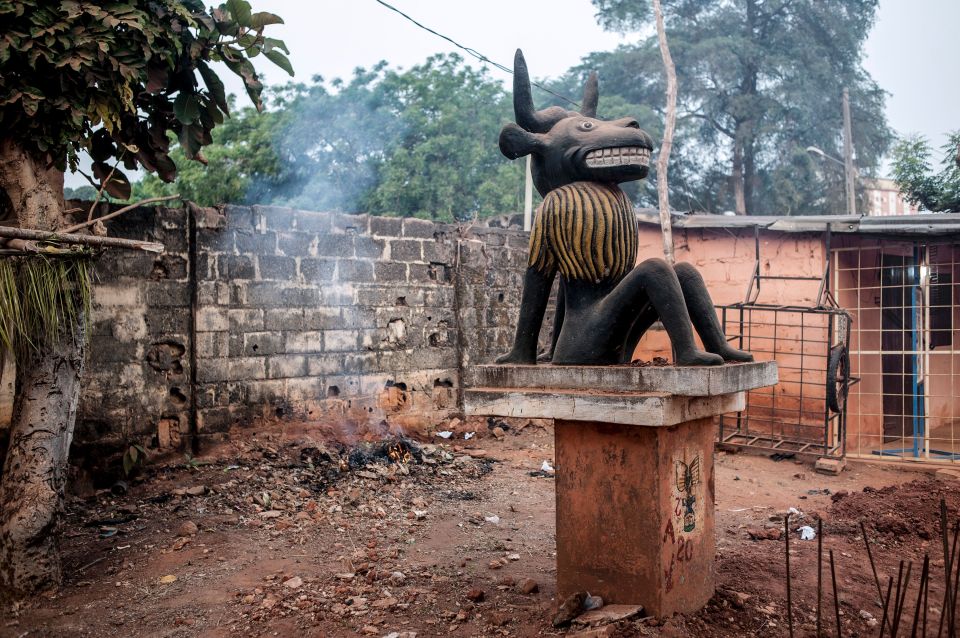 Statue of a seated bull-like figure at a Voodoo festival in Ouidah, Benin.