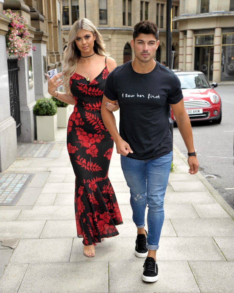 Belle Hassan and Anton Danyluk holding hands.