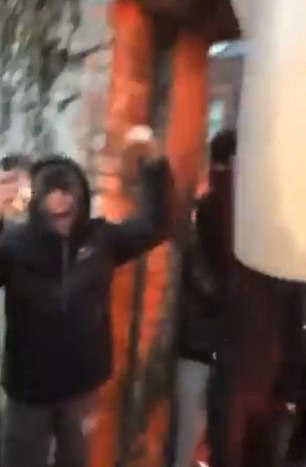 One of the masked men ran out with the kettle and was cheered by crowds outside