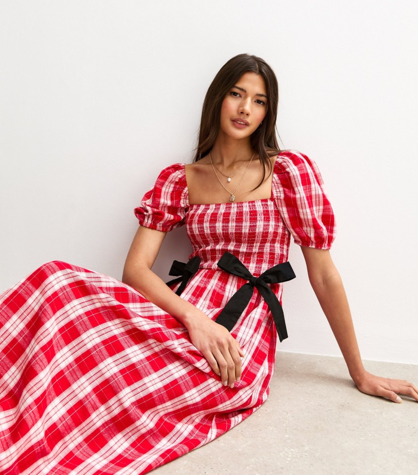 Woman in red gingham midi dress.