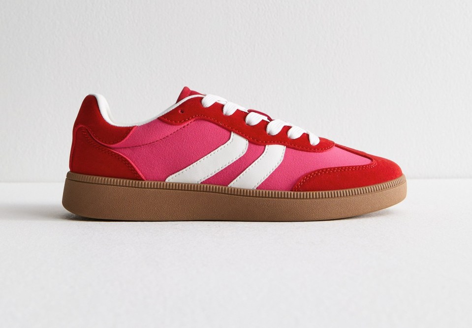 Red and pink sneaker with white stripes and a tan sole.