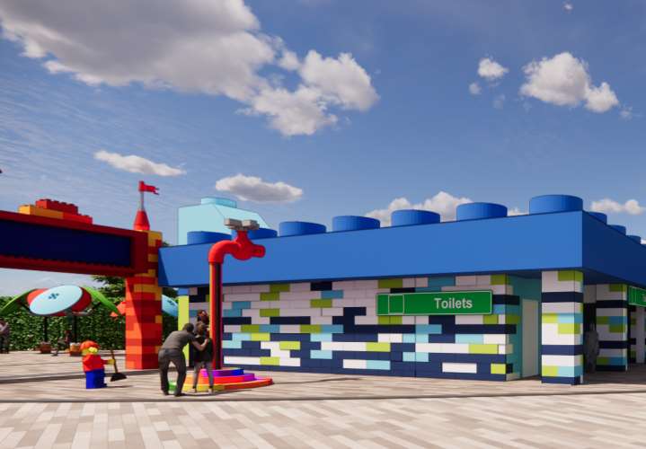 Illustration of a LEGO-themed park entrance with restrooms.