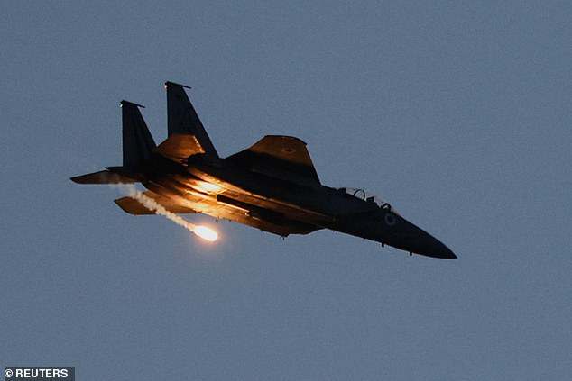 An F-15 jet releases a flare as it flies over Gaza, as seen from Israel, June 2, 2025