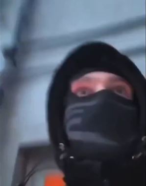 A person wearing a black balaclava.