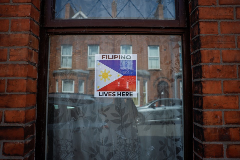 Sticker on a window displaying the Philippine flag and the words "Filipino Lives Here".