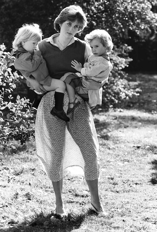 Princess Diana holding two young children.
