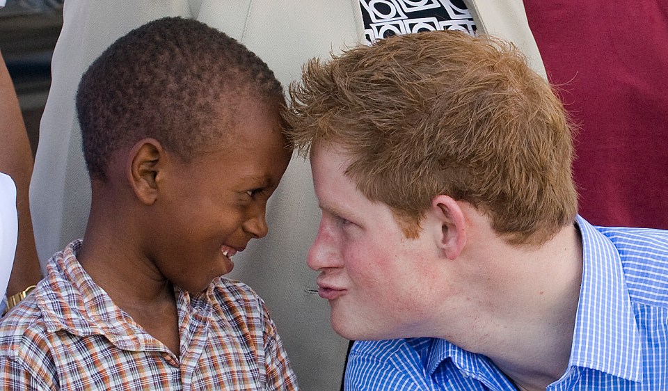 Prince Harry with a young patient at a hospital.