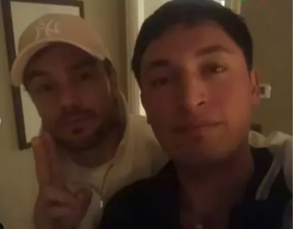 a man wearing a ny hat is next to another man