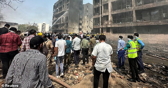 People gather near the site where an Air India plane crashed in Ahmedabad, India, June 12, 2025. REUTERS/Amit Dave