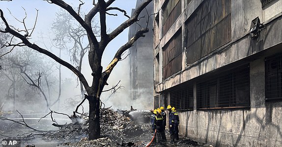 Firefighters work at the site of an airplane that crashed in India's northwestern city of Ahmedabad in Gujarat state, Thursday, June12, 2025. (AP Photo/Ajit Solanki)